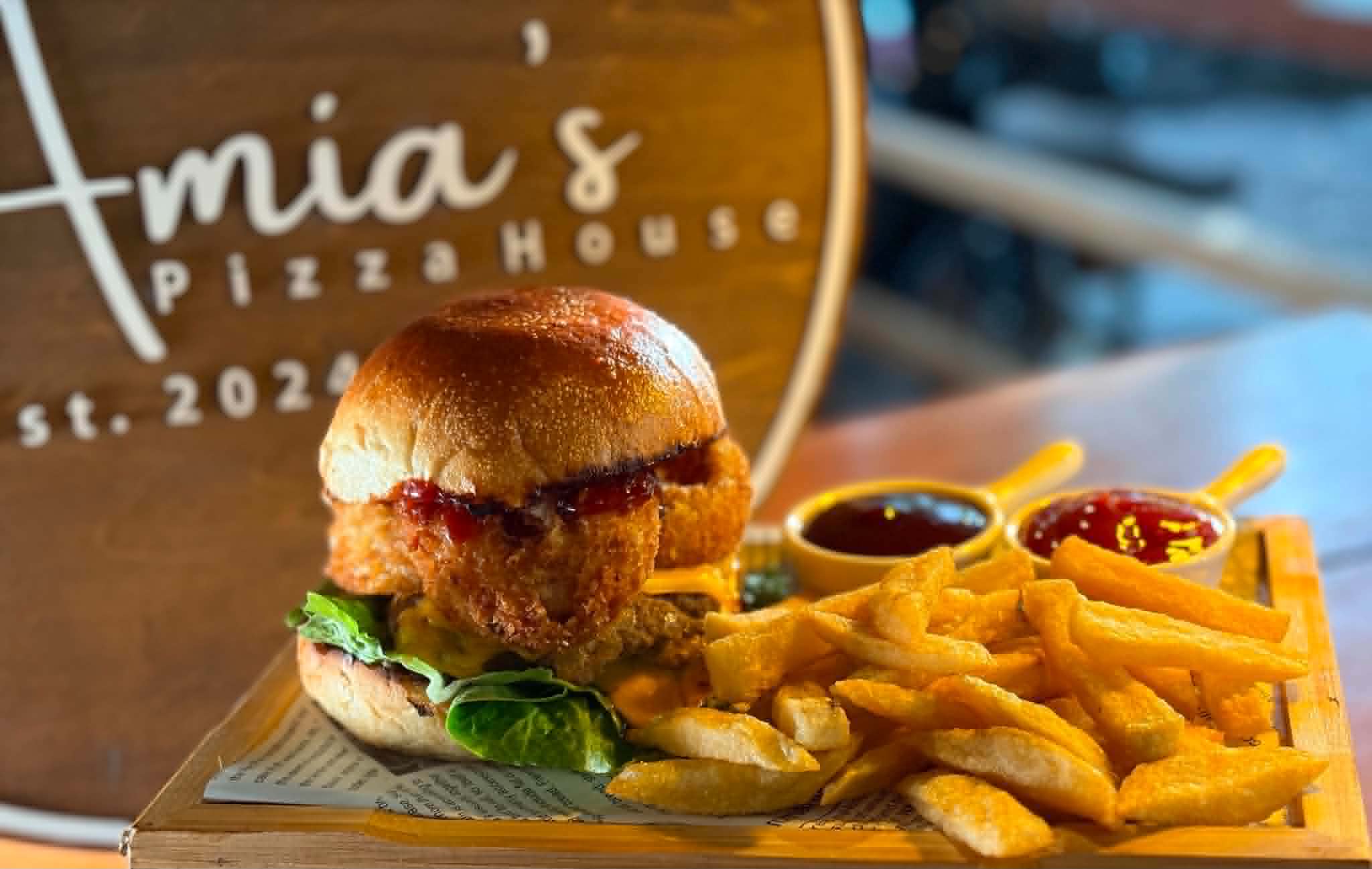 A burger and fries served at Amia’s Pizza House